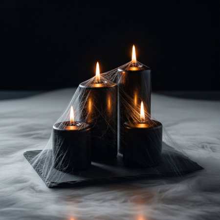 Three burning candles on a black background. The concept of halloweenの素材