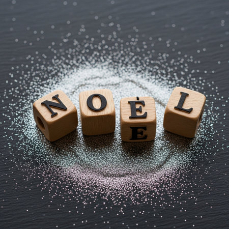 Wooden cubes with the word LOVE on a black background sprinkled with white powderの素材