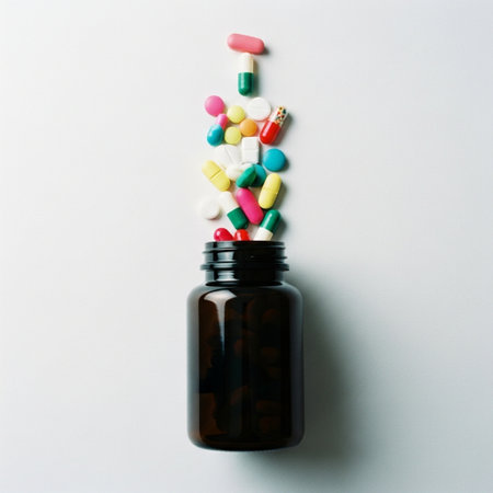 Bottle of pills and capsules on white background, top view.の素材