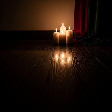 Candles on a wooden floor with a red curtain in the backgroundの素材