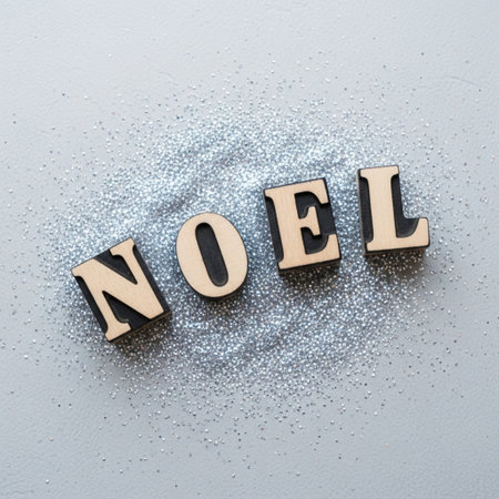 Word NOEL made of wooden letters on a white background with glitterの素材