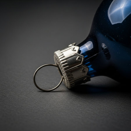 Close-up of a blue glass bottle with a key on a black backgroundの素材