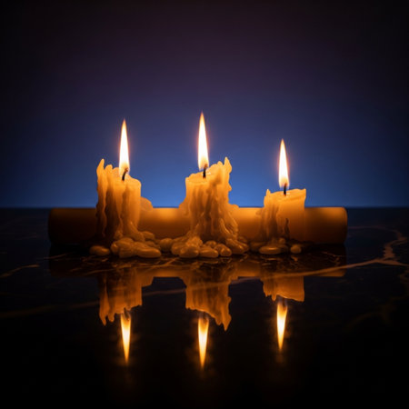 Candle light on black background with reflection and copy space for textの素材