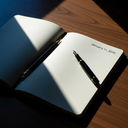 Pen and notebook on a wooden table with shadows. Selective focus.の素材