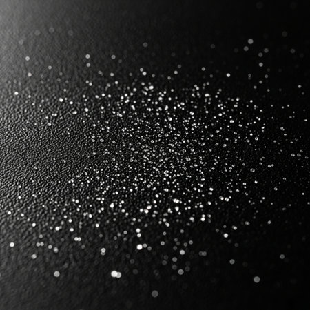 Silver glitter on a black background. Festive background with bokeh.の素材