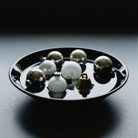 Christmas balls on a black plate on a dark background. Black background.の素材