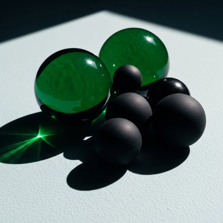 Green and black glass balls on a white background with shadow. Close-upの素材