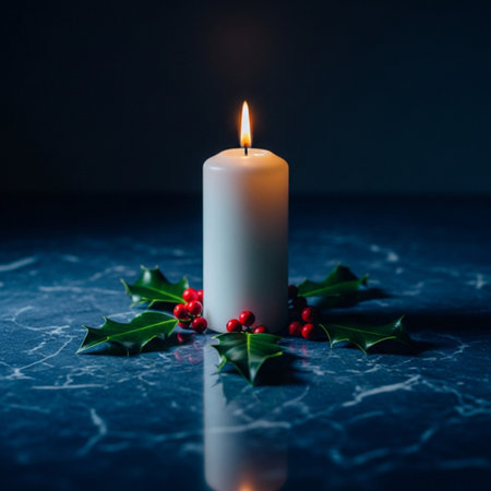 Christmas candle with holly and berries on a marble background. Copy space.の素材