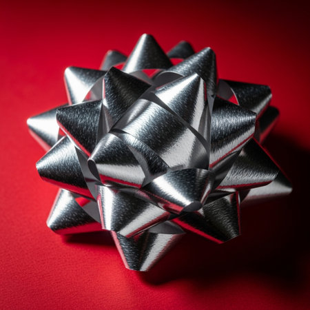 Silver gift bow on a red background. Close-up photo.の素材