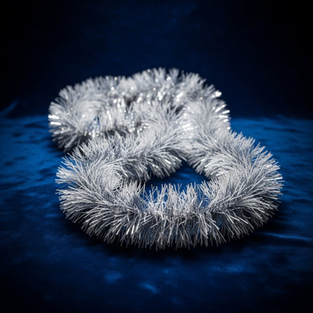 Silver Christmas tinsel on blue background. Shallow depth of field. Toned.の素材