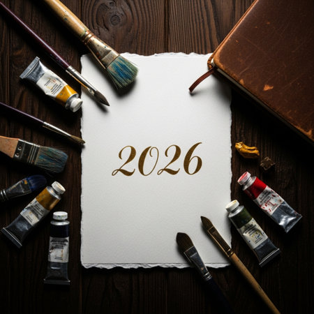 Paint brushes, paints and notebook with the inscription 2016 on a wooden backgroundの素材