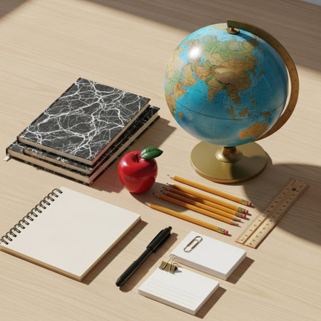Notebook, pencils, globe and apple on a wooden table.の素材