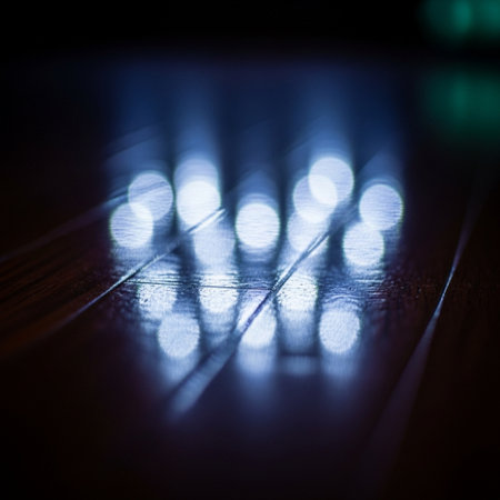 LED strip on wooden floor in dark room. Selective focus.の素材