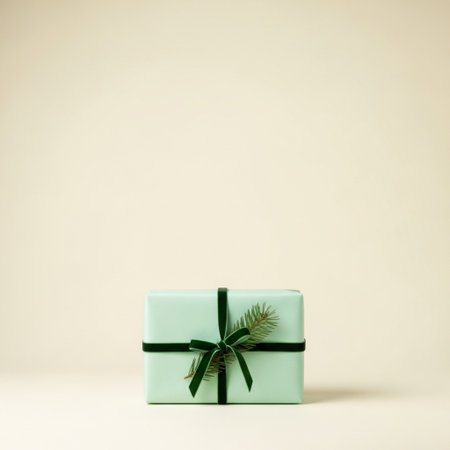 Green gift box with a green ribbon on a beige background.の素材
