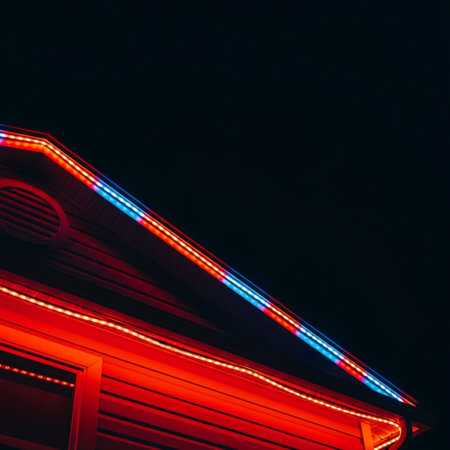 Red and blue neon lights on the roof of a house in the nightの素材