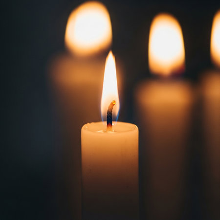 Burning candles on dark background, close-up, selective focusの素材