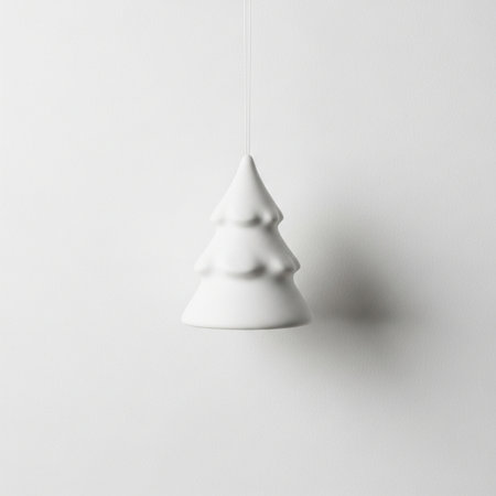 Christmas tree hanging on the white wall. Minimalistic concept.の素材