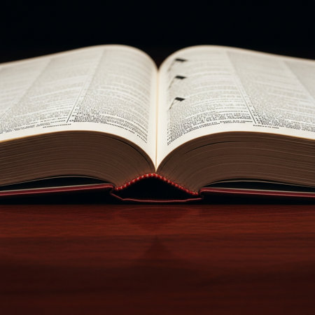 Open book on a wooden table with shallow depth of field. Toned.の素材