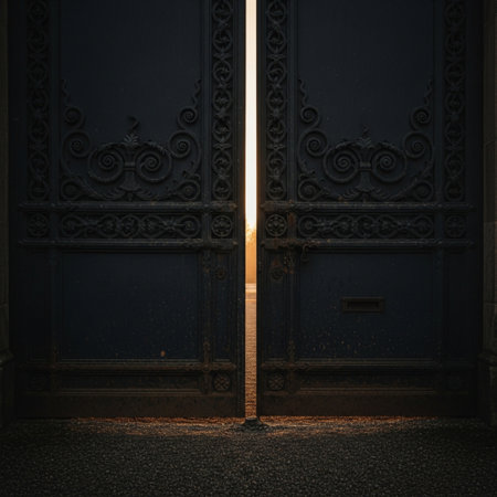 Old metal gate at the entrance to a dark room with a beautiful light.の素材