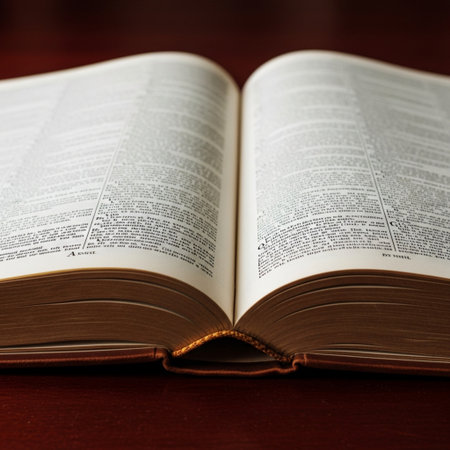 Open book on a wooden table. Shallow depth of field.の素材