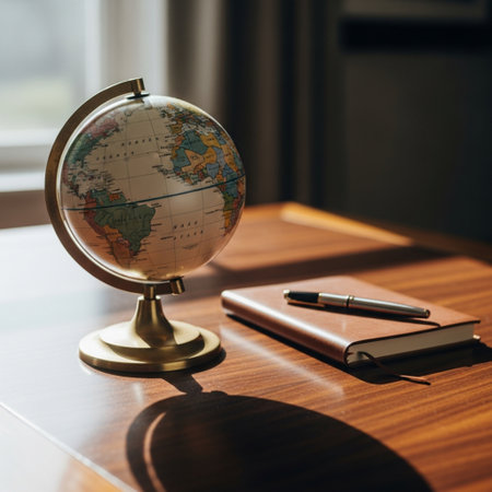 Globe, notebook and pen on the table in the office.の素材