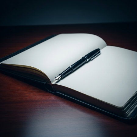 Notebook and pen on a wooden table. Selective focus.の素材