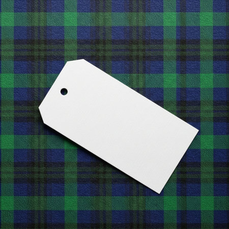 Blank price tag on a tartan plaid pattern background.の素材