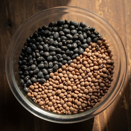 Black and red lentils in a glass bowl on a wooden tableの素材