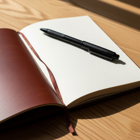 Notebook and pen on a wooden table. View from above.の素材