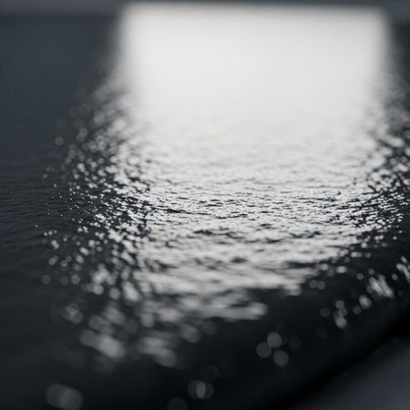 Macro detail of water droplets on a black leather cover.の素材