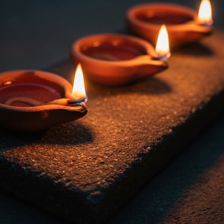 Burning diya lamps on dark background for diwali festivalの素材