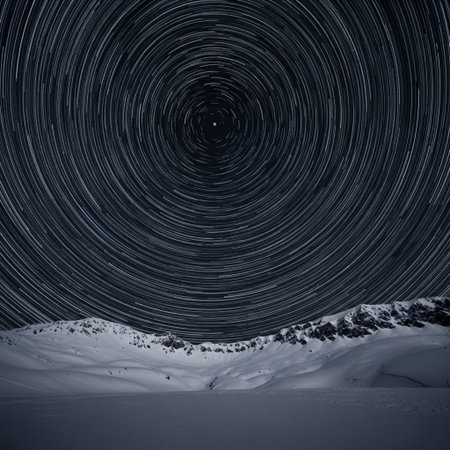 Star trails in the night sky over mountains. Beautiful winter landscape.の素材