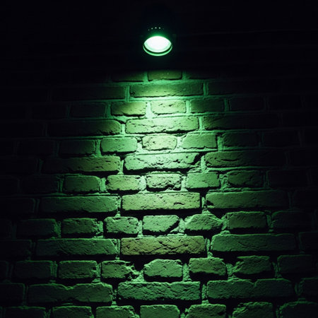 Green led lamp on brick wall background with copy space for text.の素材