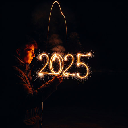New Year and Christmas concept - man holding a sparkler on dark backgroundの素材