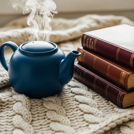 Cup of hot tea with books on knitted plaid backgroundの素材