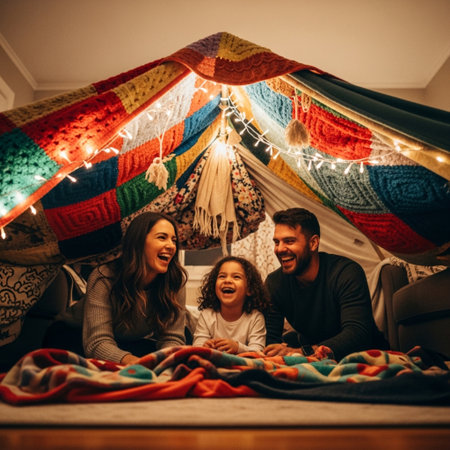 Happy family in a tent at home. Mother, father and their daughter are having fun together.の素材