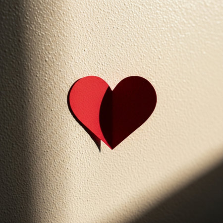 Red paper heart on white wall background. Valentines day concept.の素材