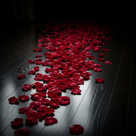 Red rose petals on wooden floor in dark room. Valentines day backgroundの素材