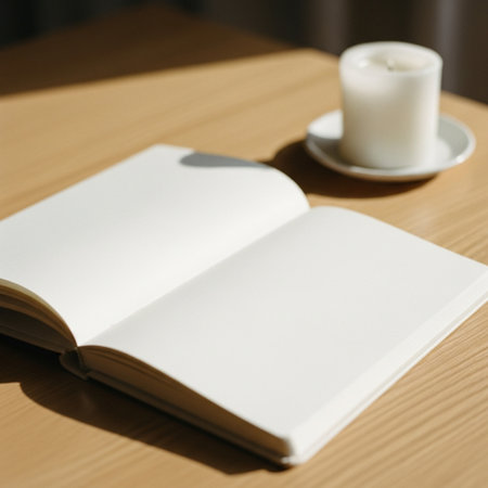Open book with a cup of coffee on the wooden table in the morningの素材