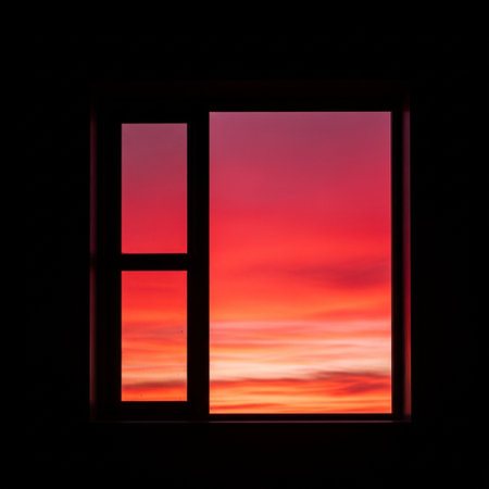 Silhouette of a window with a view of the sunset.の素材