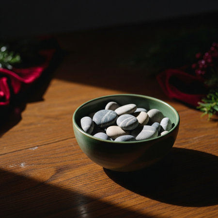 Stones in a green bowl on a wooden table with Christmas decorationsの素材