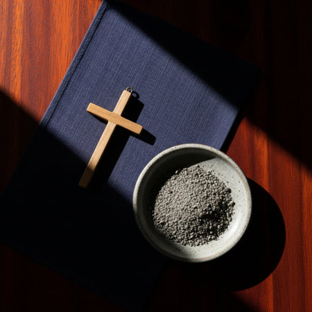 Bowl of ash and a cross on a dark wooden table.の素材