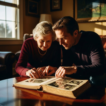 Elderly woman and her adult son are reading a book.の素材