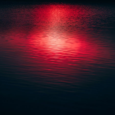 Reflection of the sun on the water surface. Red background.の素材