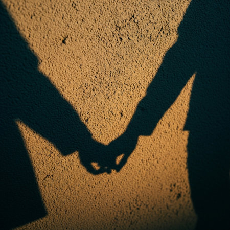 Silhouette of man and woman holding hands on a yellow backgroundの素材