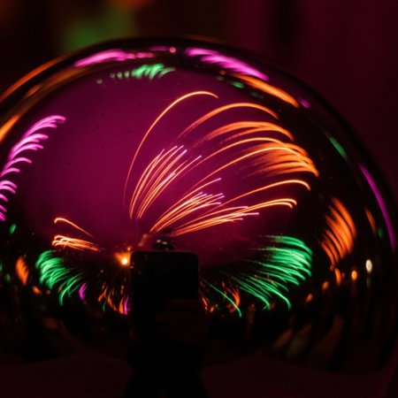 Colorful firework in a crystal ball. The ball is decorated with bright lights.の素材