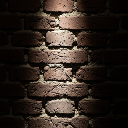 Cinematic Dutch angle of exposed brick wall texture under a harsh spotlight and sunlight.の素材