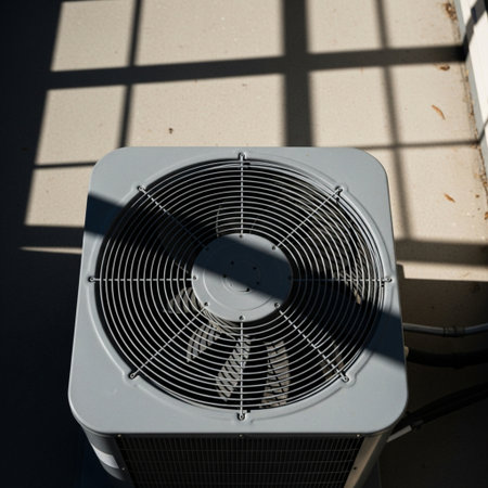 High angle top-down shot of a metallic central air conditioning unit running smoothly outside a subuの素材