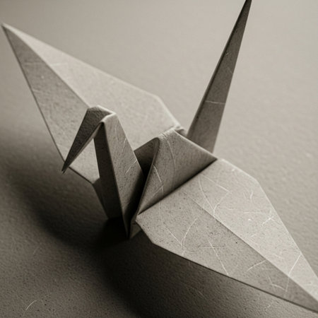 Paper origami crane on a gray background. Close-up.の素材