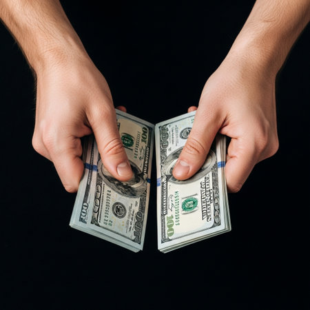 High angle, detailed close-up of a person's hands performing a meticulous count of multiple stacks oの素材